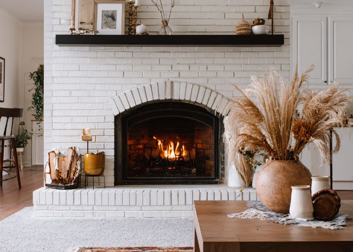 home with painted white brick fireplace & fall decor